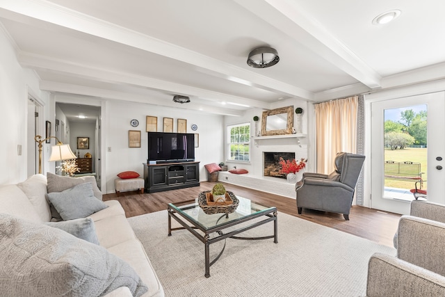 living room with hardwood / wood-style floors and beam ceiling