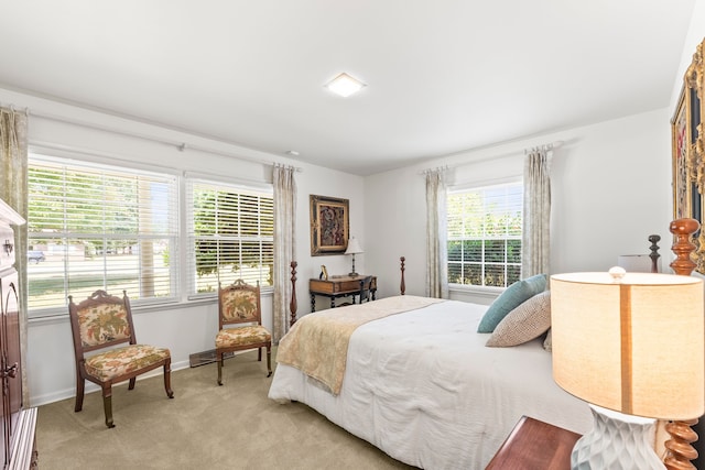 carpeted bedroom featuring multiple windows