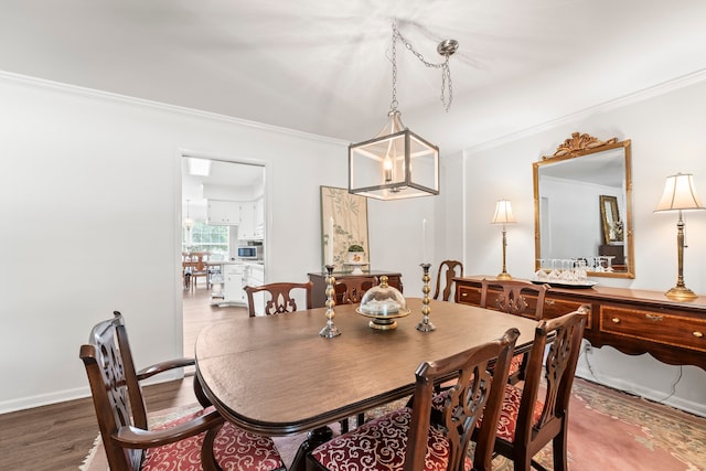 dining area featuring crown molding and hardwood / wood-style flooring