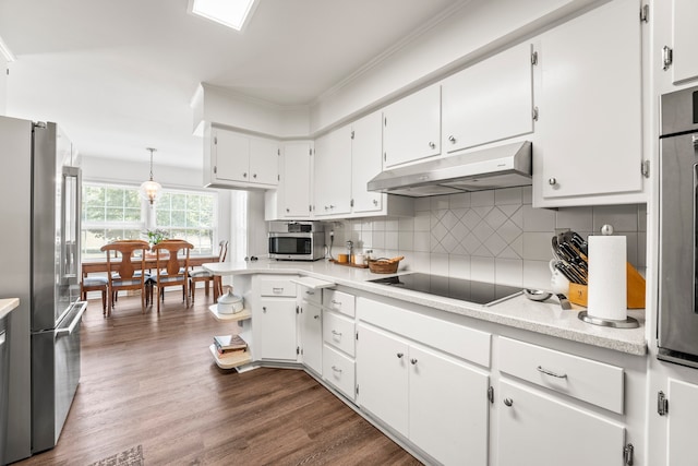 kitchen featuring dark wood-type flooring, appliances with stainless steel finishes, white cabinetry, and tasteful backsplash