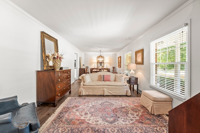 bedroom featuring crown molding, dark wood-type flooring, and a notable chandelier