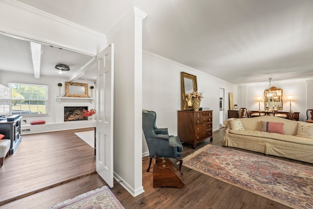 living room featuring ornamental molding, hardwood / wood-style floors, and a notable chandelier