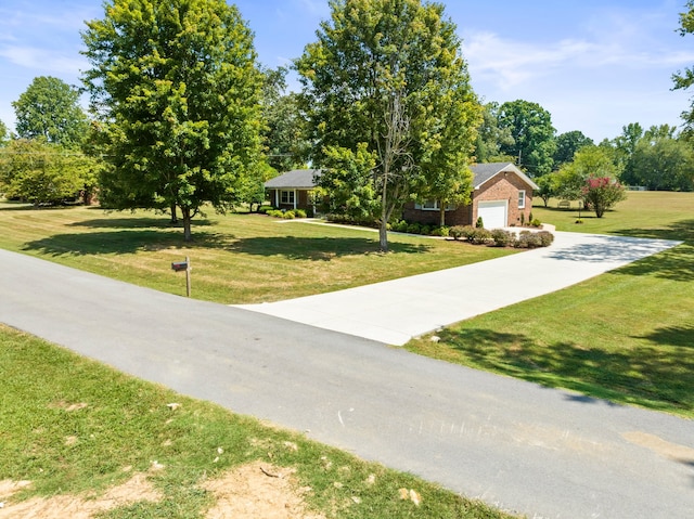 view of front of home with a front lawn and a garage