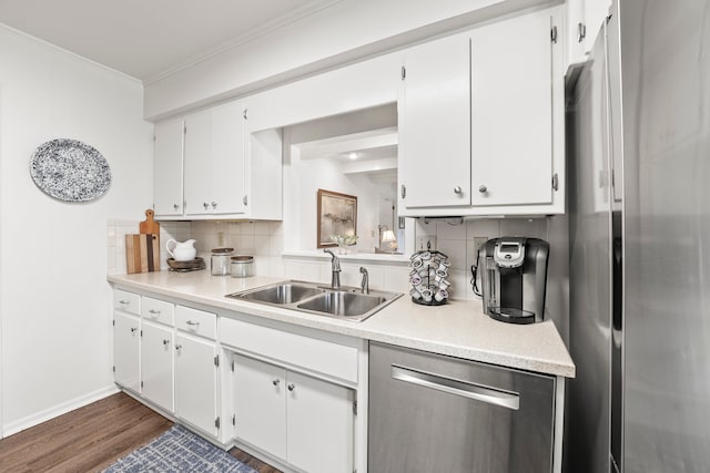 kitchen featuring white cabinets, stainless steel appliances, sink, dark wood-type flooring, and tasteful backsplash