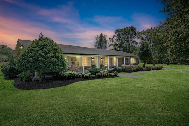 ranch-style house featuring a lawn