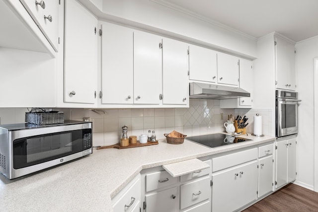 kitchen featuring white cabinets, hardwood / wood-style flooring, stainless steel appliances, and decorative backsplash