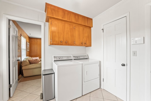 laundry room with crown molding, cabinets, independent washer and dryer, and light tile patterned flooring