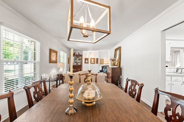 dining room with ornamental molding, wood-type flooring, and sink