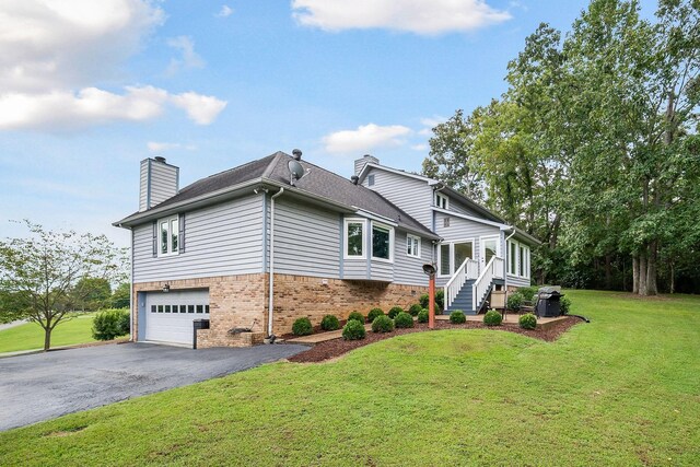 view of front facade with a garage and a front lawn