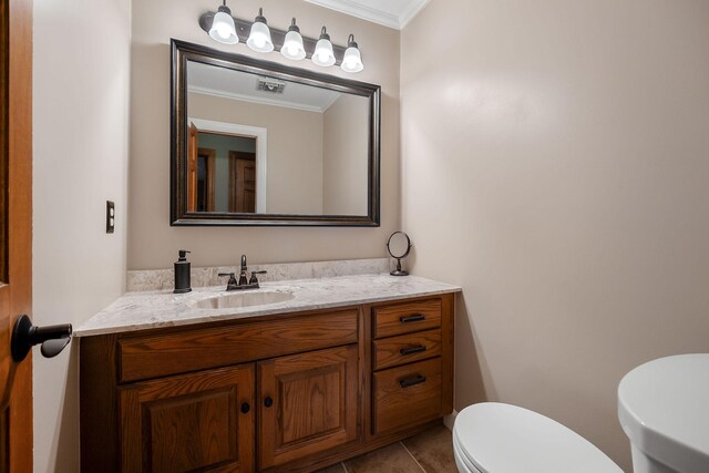 bathroom featuring tile patterned flooring, toilet, crown molding, and vanity