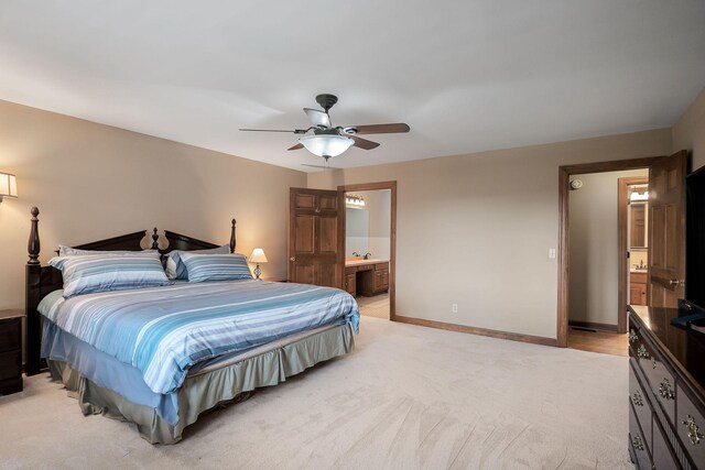 carpeted bedroom with connected bathroom and ceiling fan