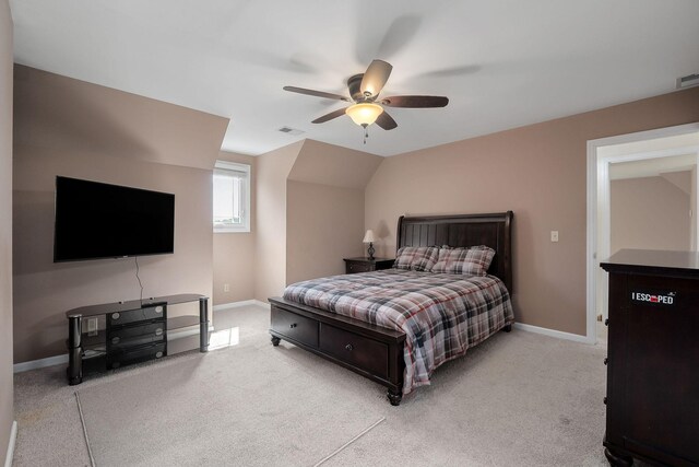 bedroom with lofted ceiling, ceiling fan, and light colored carpet