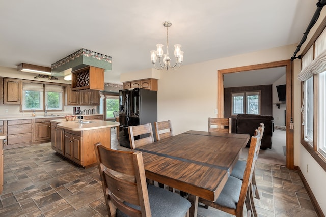 dining room with an inviting chandelier and sink