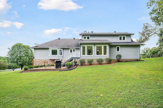 back of property with a yard and a patio area