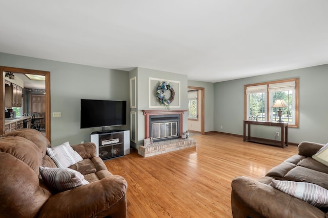 living room with a fireplace and light hardwood / wood-style flooring