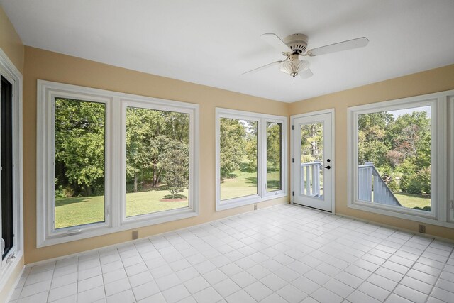 unfurnished sunroom featuring a wealth of natural light and ceiling fan