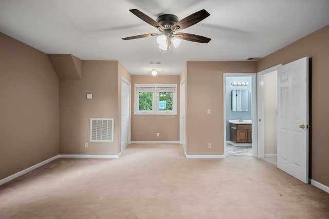 carpeted spare room featuring sink and ceiling fan