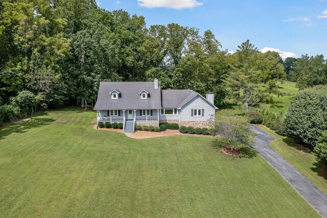 view of front of house featuring a front yard and covered porch