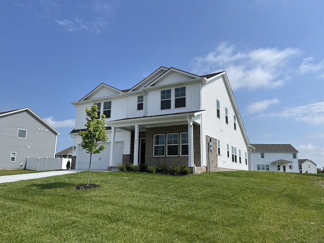 view of front facade featuring a front lawn, driveway, brick siding, and an attached garage