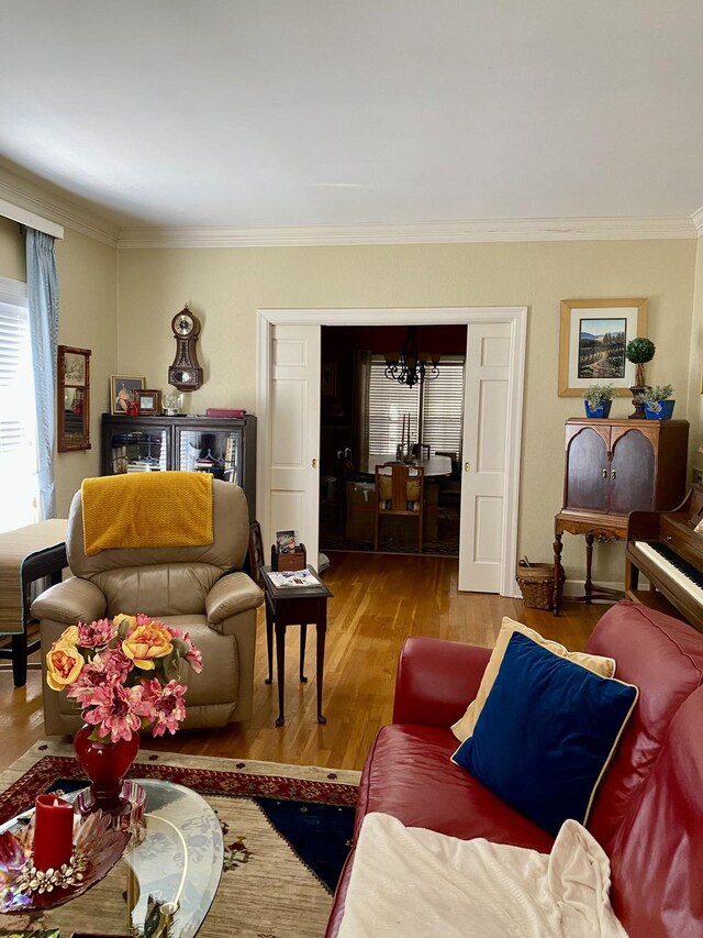 living room with hardwood / wood-style flooring and crown molding