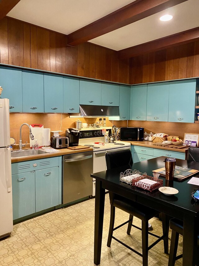 kitchen with white appliances, beam ceiling, sink, and blue cabinetry