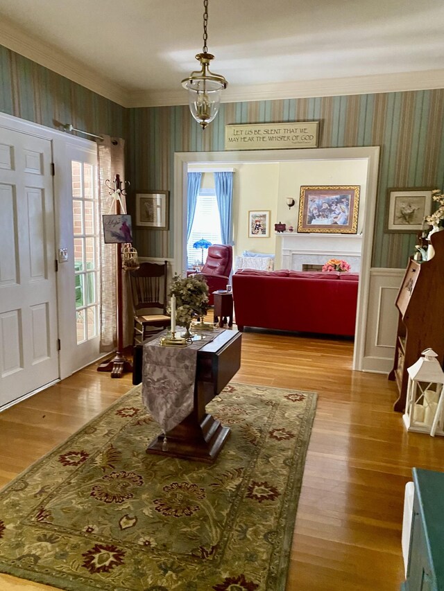 dining room with ornamental molding, light wood-type flooring, and a chandelier