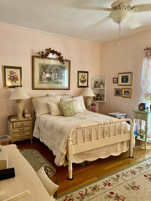 bedroom featuring wood-type flooring and ceiling fan