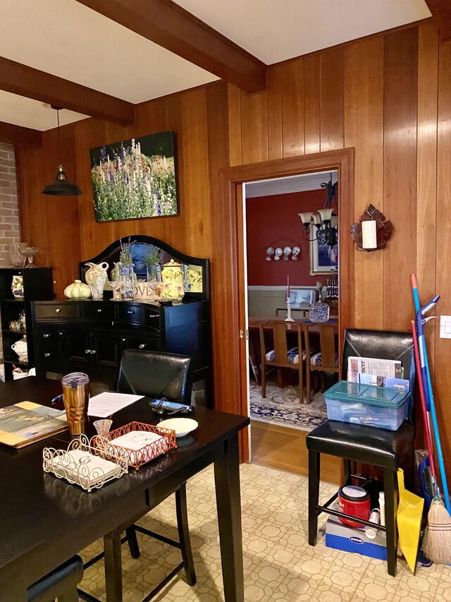 home office with wooden walls and beamed ceiling