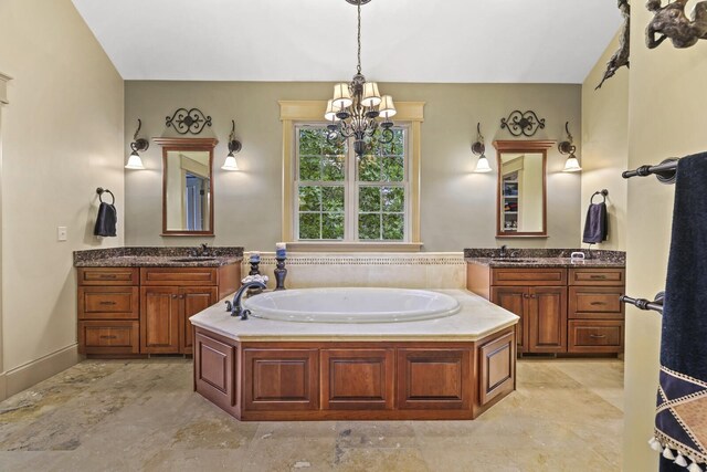 bathroom featuring a bath, a chandelier, and vanity