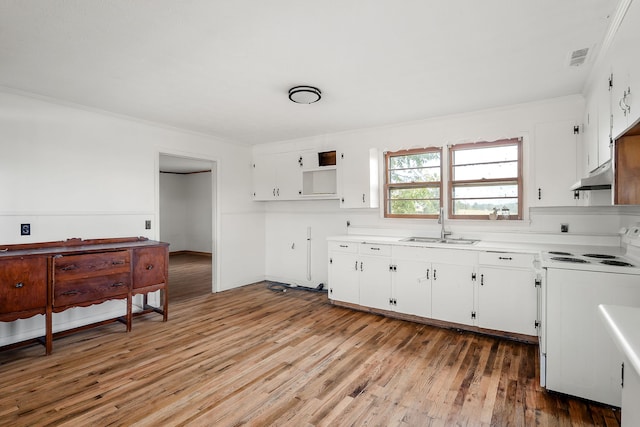 kitchen featuring white cabinets, hardwood / wood-style flooring, electric stove, and sink