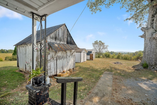 view of yard featuring a rural view and a storage unit