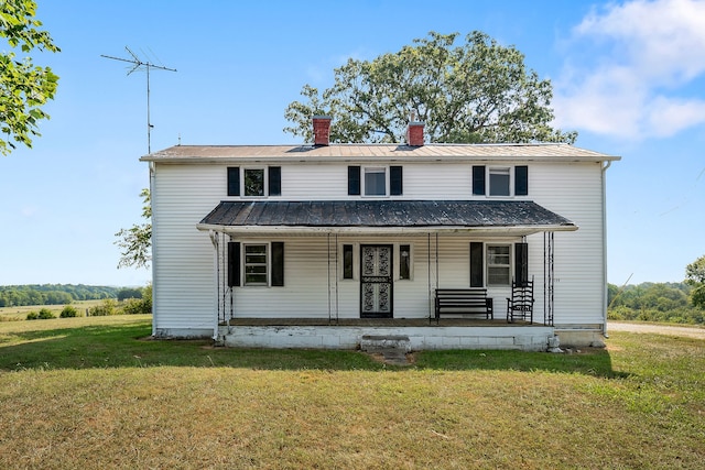 view of front of home with covered porch and a front lawn