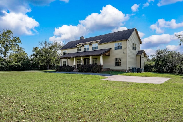 back of house featuring a yard and central AC