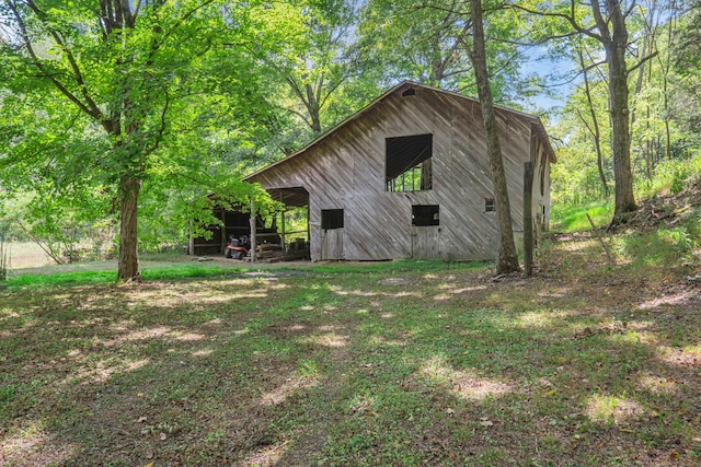 view of property exterior with an outbuilding