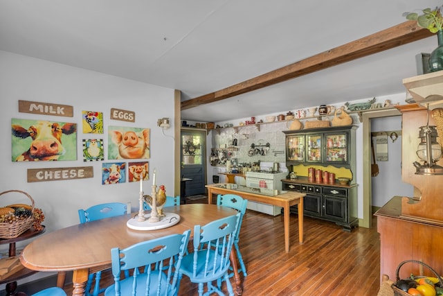 dining room featuring dark hardwood / wood-style flooring and beamed ceiling