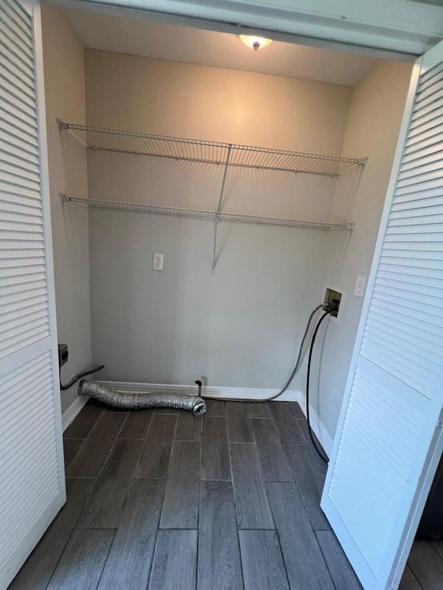 laundry area with hookup for a washing machine, hookup for an electric dryer, laundry area, baseboards, and dark wood-style floors