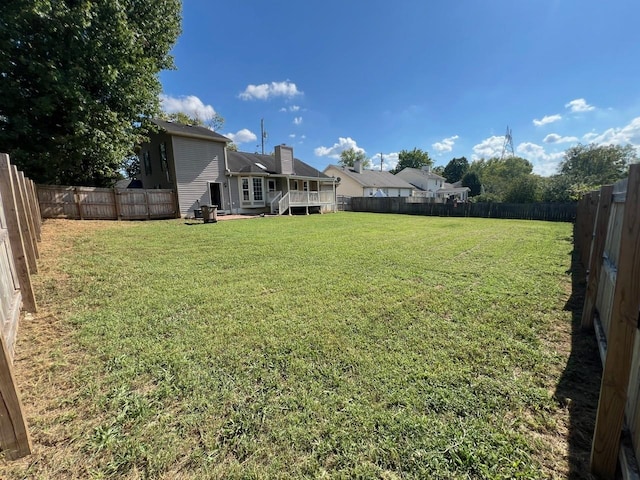 view of yard with a fenced backyard and a deck