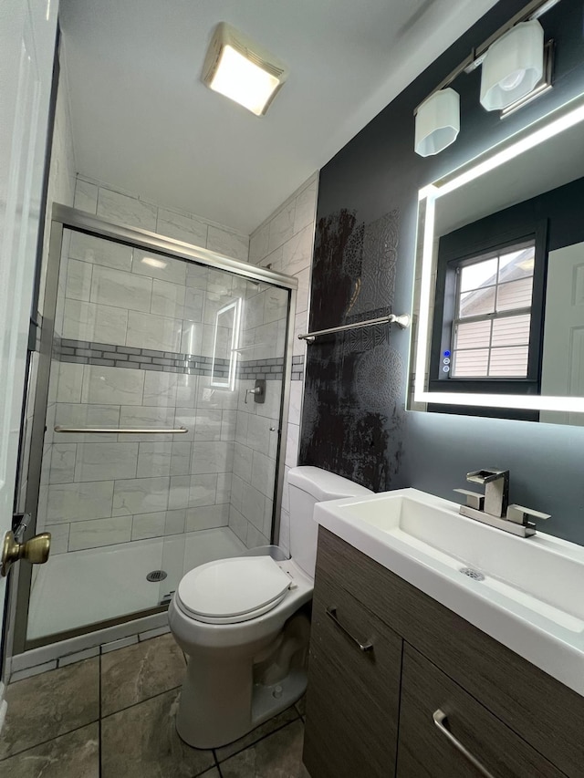 full bath featuring vanity, a shower stall, and toilet