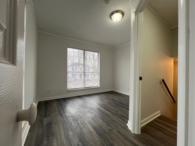 interior space featuring ornamental molding, dark wood finished floors, and baseboards