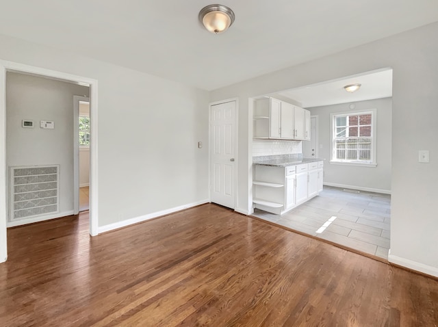 unfurnished living room featuring hardwood / wood-style flooring