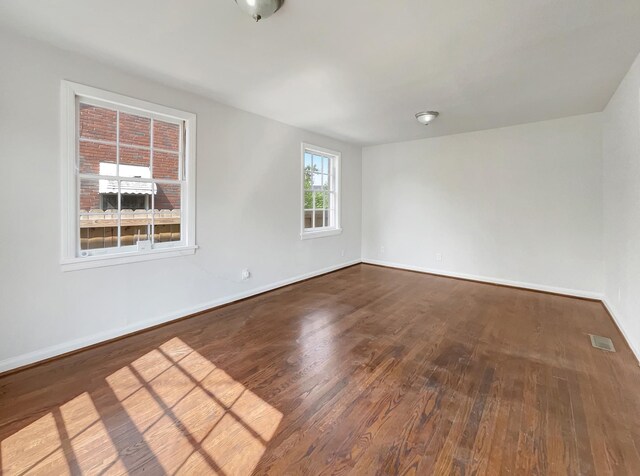 unfurnished room featuring hardwood / wood-style flooring