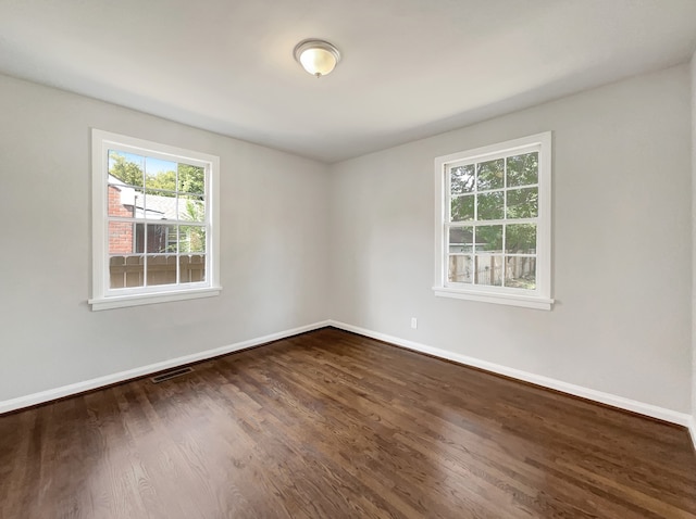 empty room with dark hardwood / wood-style floors