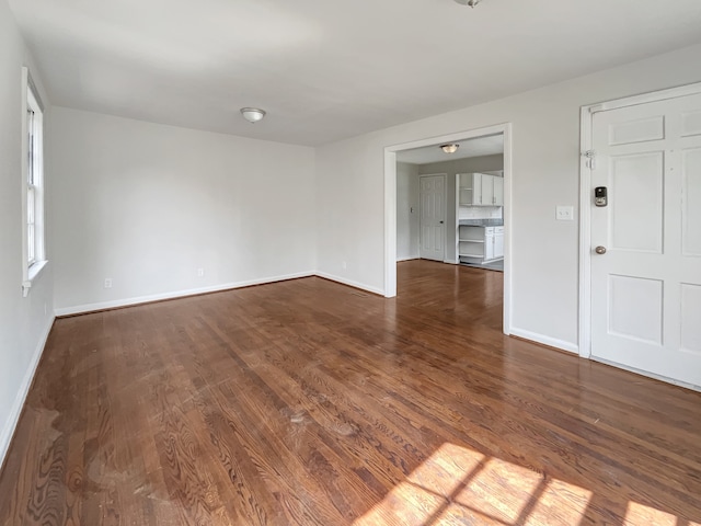 empty room featuring dark wood-type flooring