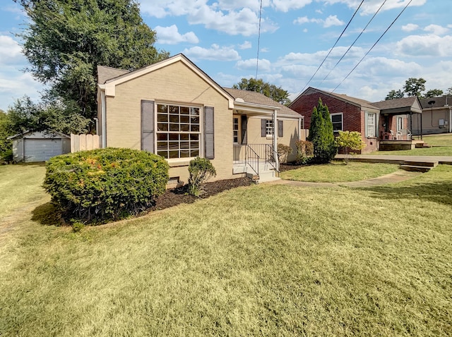 view of front of home with an outdoor structure, a garage, and a front lawn