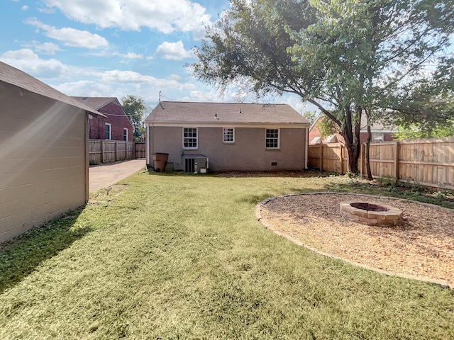 view of yard with an outdoor fire pit and cooling unit