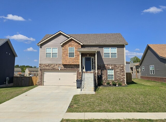 view of front of home with a front yard and a garage