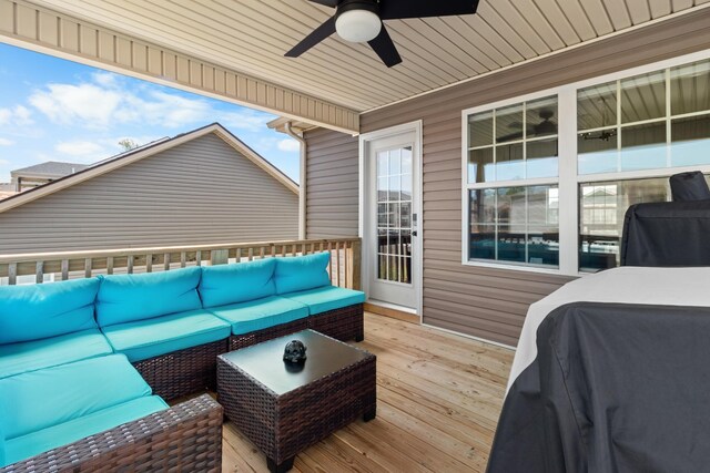 wooden terrace with area for grilling, outdoor lounge area, and ceiling fan