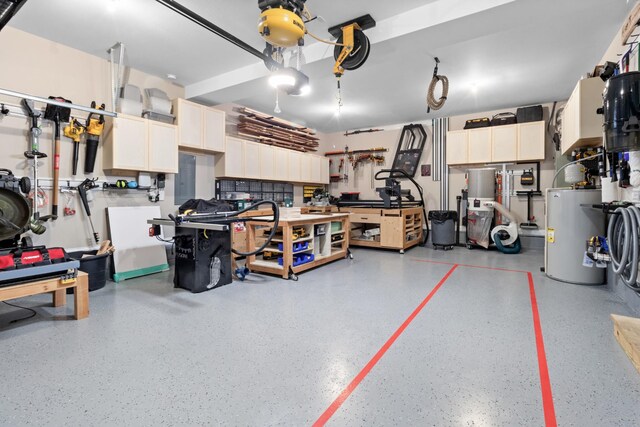 garage with water heater and a workshop area