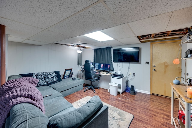 living room with a paneled ceiling and hardwood / wood-style floors