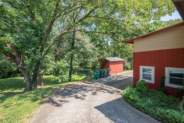 exterior space featuring a storage shed and a lawn